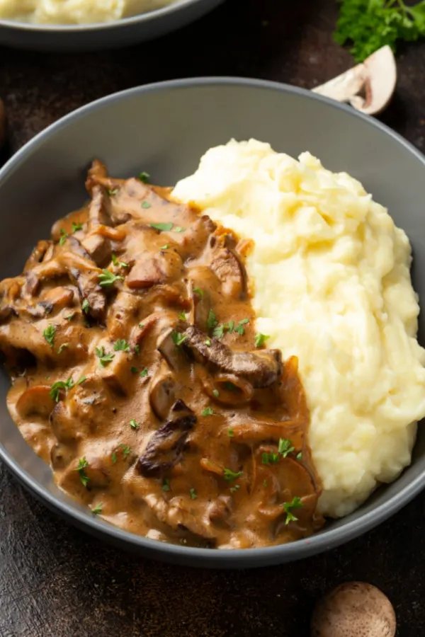 beef stroganoff served with mashed potatoes