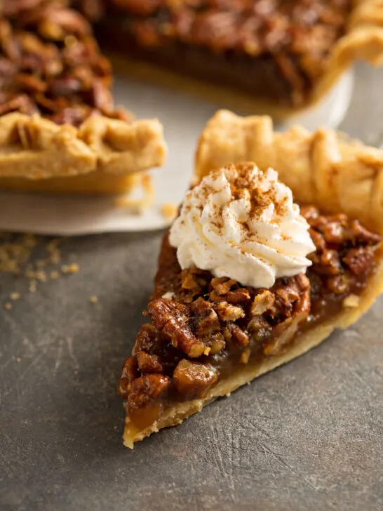 easy pecan pie recipe with a slice of pie with whipped topping