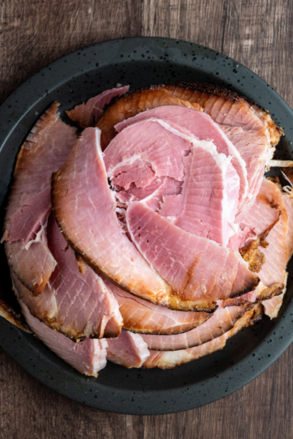 slices of spiral ham cut and in a black bowl