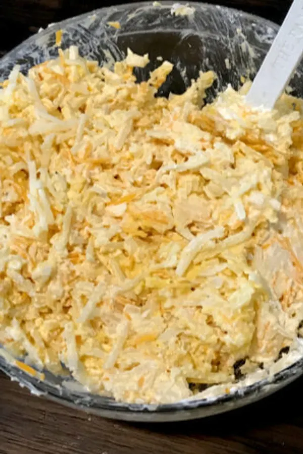 shredded potatoes being stirred with cream of chicken soup