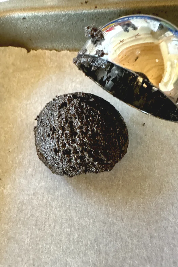 an Oreo truffle ball ready to be dipped in a chocolate topping.
