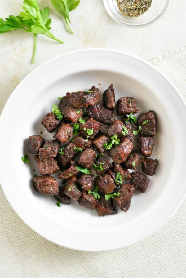 pieces of steak in a white bowl