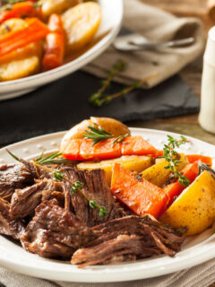 pot roast and vegetables on white plate