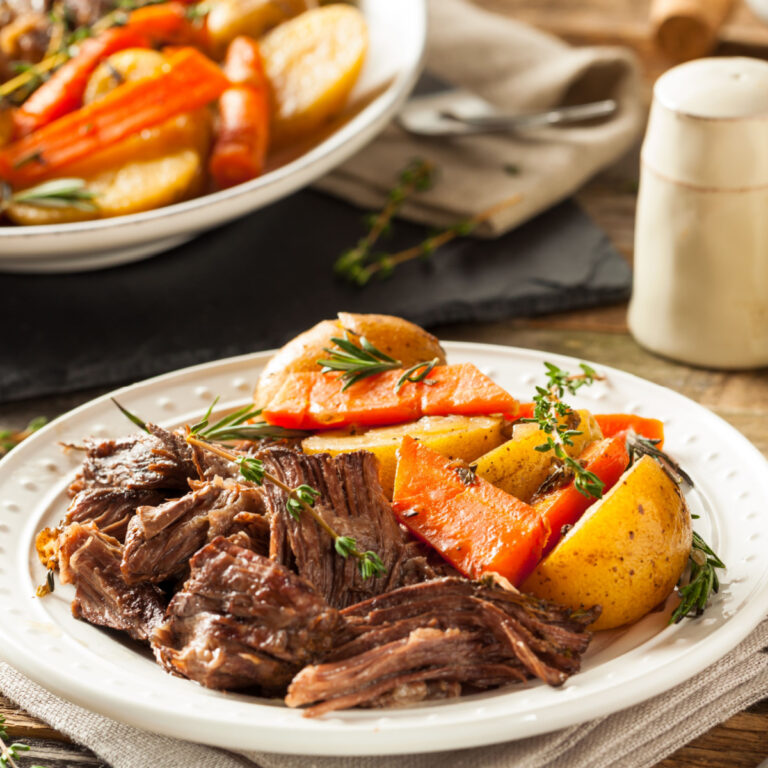 pot roast and vegetables on white plate