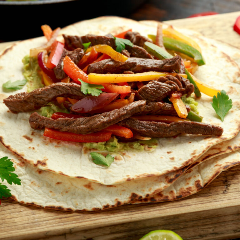 steak fajita on stack of tortillas