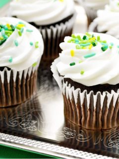 Guinness cupcakes with Bailelys Irish Cream frosting and green sprinkles.