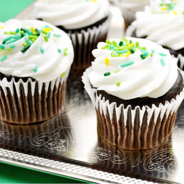 Guinness cupcakes with Bailelys Irish Cream frosting and green sprinkles.