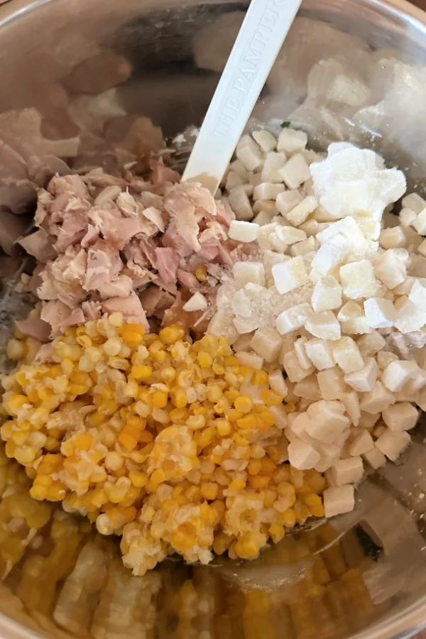 chicken corn and potatoes in a bowl