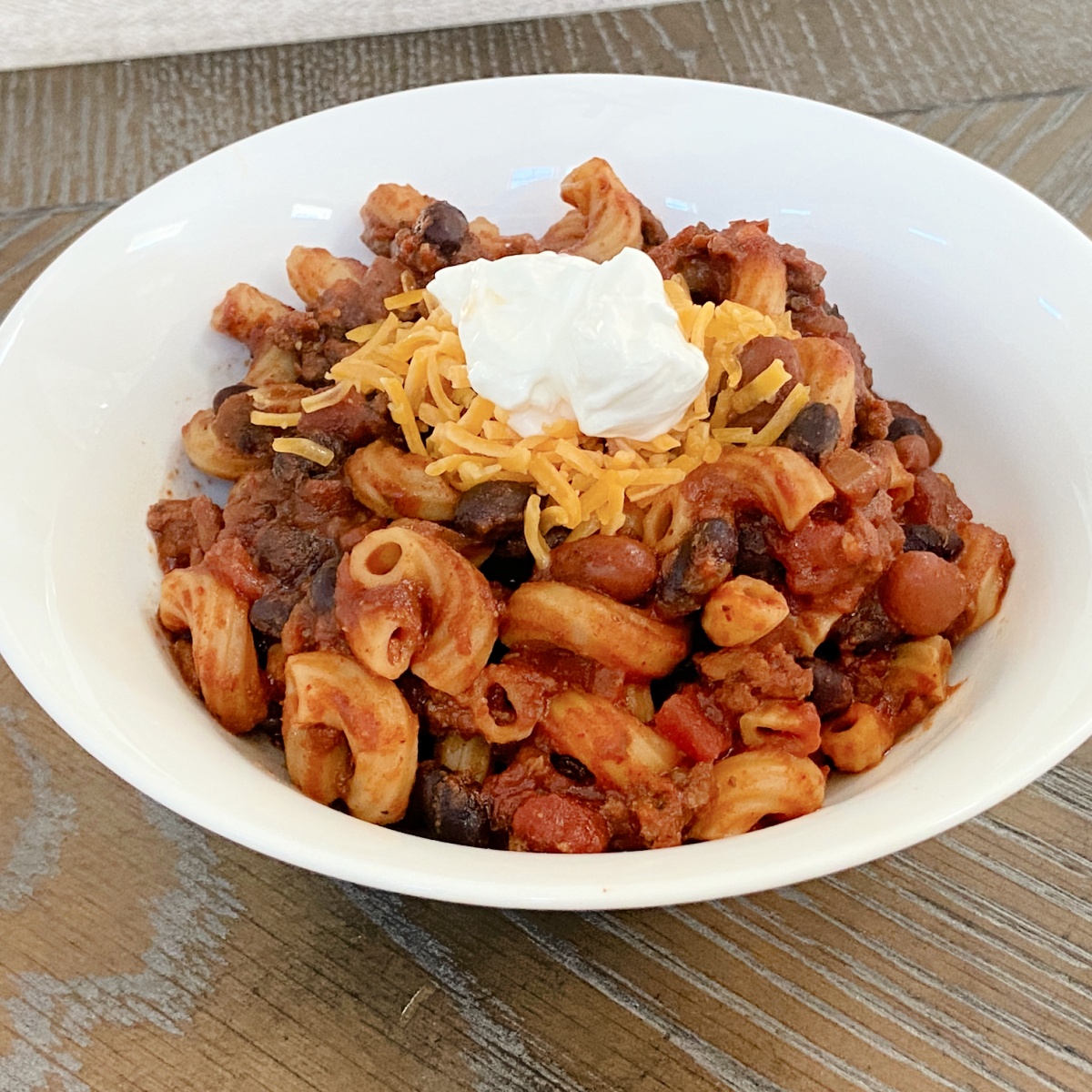 crock pot chili mac in white bowl