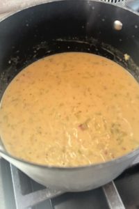 adding cheese to soup
