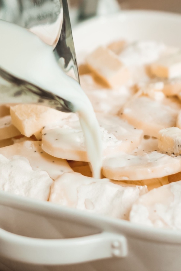 pouring milk on potatoes