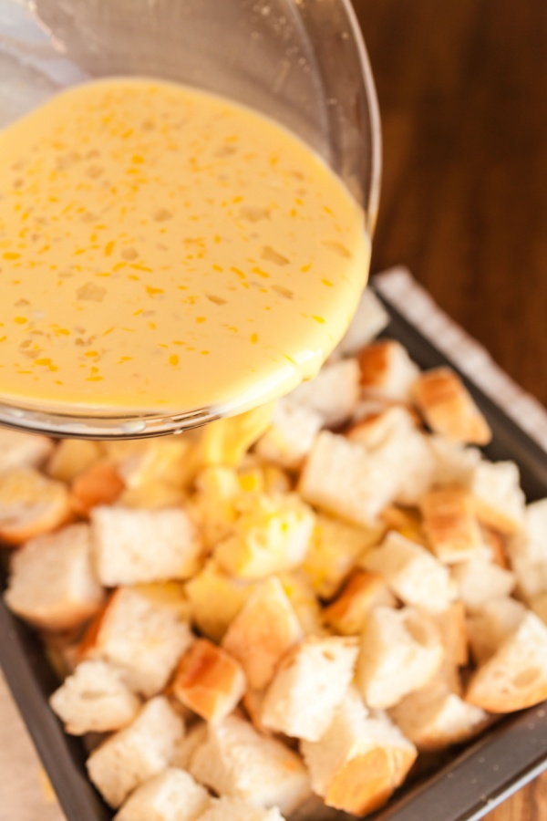 egg mixture over cubes of bread